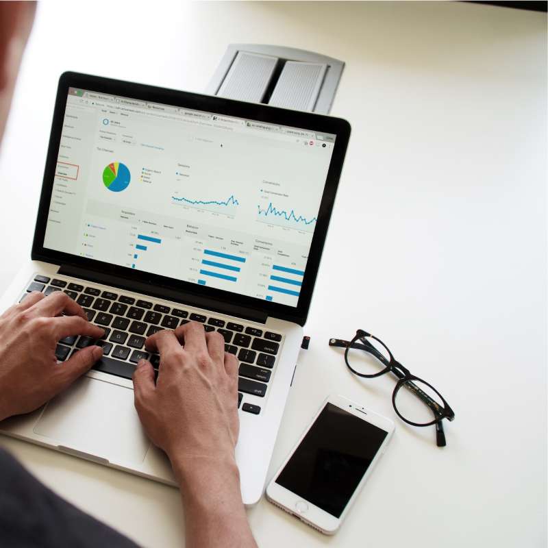 manager looking over grown numbers on a computer screen
